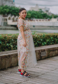 Portrait of a smiling young woman standing outdoors