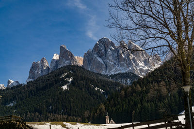 Low angle view of mountains against blue sky