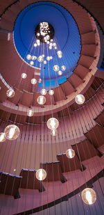 Low angle view of illuminated chandelier hanging from ceiling