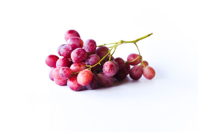 Close-up of grapes over white background