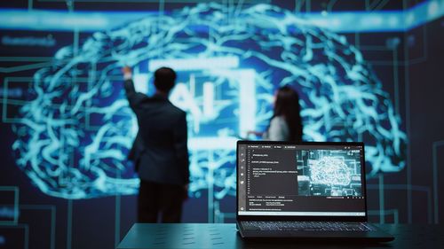 Digital composite image of businessman using laptop at office