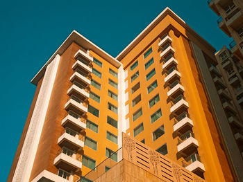 Low angle view of residential building against clear blue sky