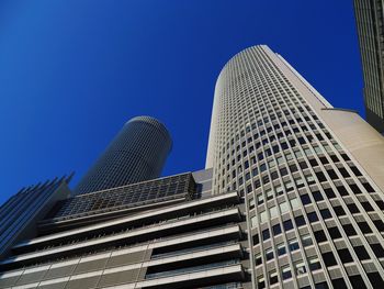 Low angle view of modern building against clear blue sky