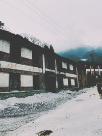 Snow covered built structure against sky