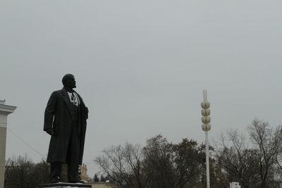 Rear view of man standing against sky