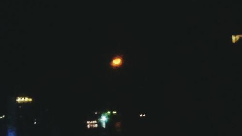 Low angle view of illuminated moon at night