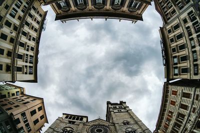 Low angle view of buildings against cloudy sky