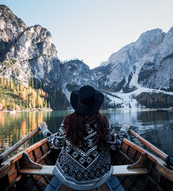 Woman looking at lake against mountain range