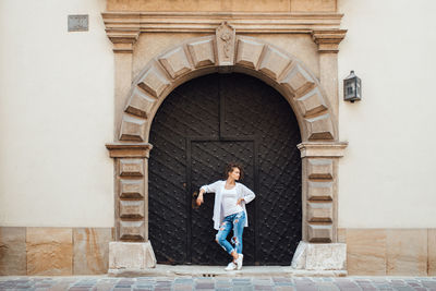 Full length of a man standing against building