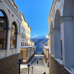 Buildings in city against clear sky