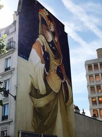 Low angle view of statue against sky in city