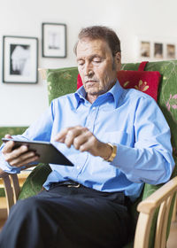 Senior man using digital tablet at nursing home