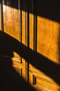 Full frame shot of wooden door in bright room