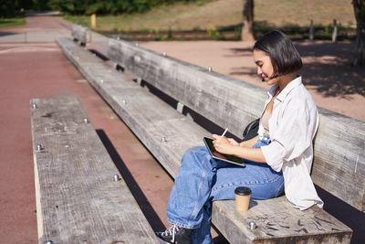 Young woman sitting on bench