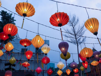 Low angle view of lanterns hanging against sky