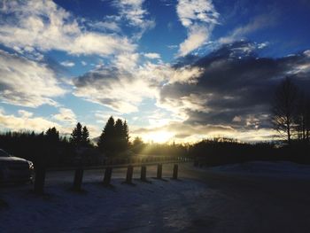 Scenic view of field against sky at sunset