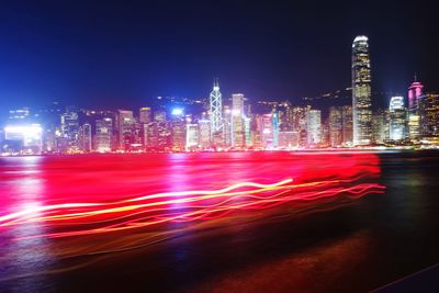 Illuminated buildings against sky at night