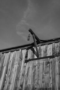 Low angle view of metallic structure against wall