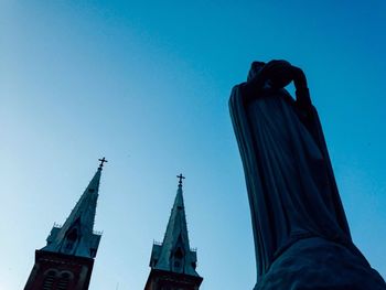 Low angle view of statue against clear blue sky