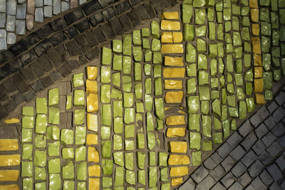 Mosaic texture. wall is made of pieces of glass. colored stone. architecture details.