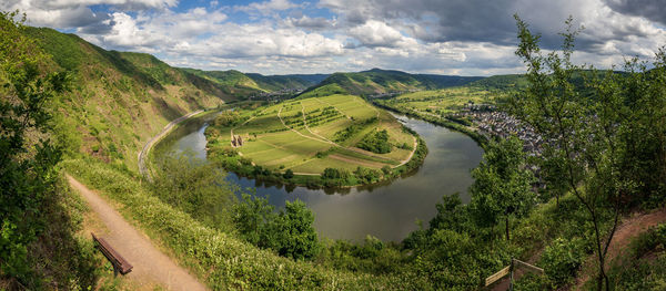 Scenic view of landscape with river against sky