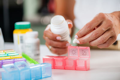 Cropped hand of person holding pills