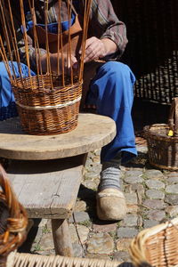 Low section of man making basket