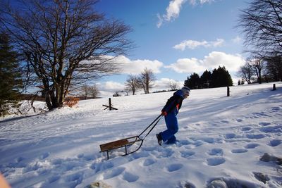 Man on snow field against sky