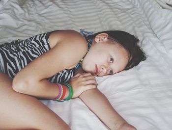 High angle view of girl lying on bed at home