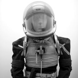 Mid section of person wearing mask against white background