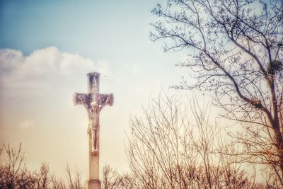 Low angle view of cross against sky