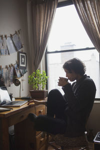 Man sitting on table at home