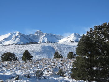 Scenic view of snowcapped mountains against clear blue sky