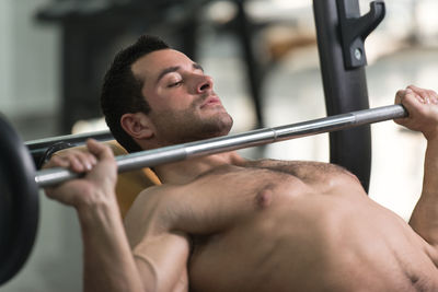 Muscular man exercising in gym