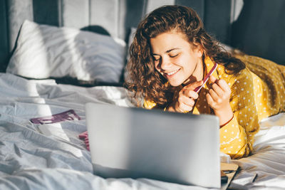 Young woman using laptop at home