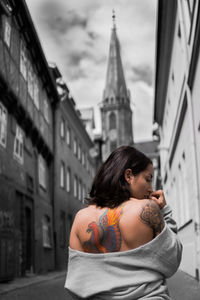 Rear view of woman with tattoo on back