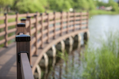 Close-up of wooden railing on footbridge