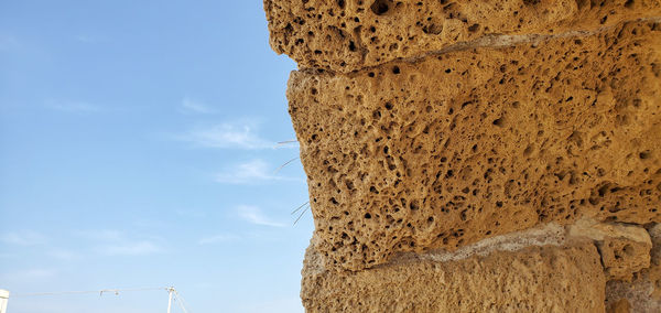Low angle view of rock formation against sky