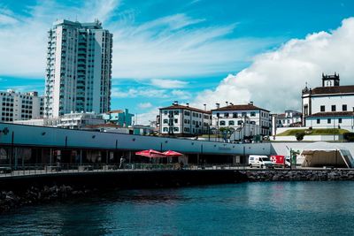 Boats in river with buildings in background