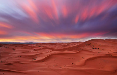 Scenic view of desert against sky during sunset