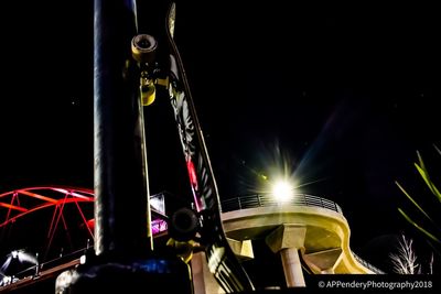 Low angle view of illuminated ferris wheel at night