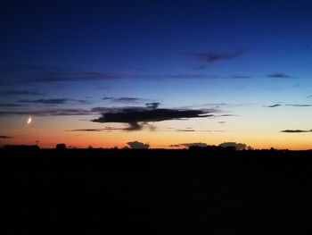 Silhouette landscape against sky at sunset