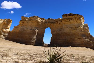 Rock formations in desert against blue sky