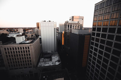 Buildings in city against clear sky