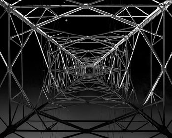 Low angle view of illuminated lights against sky at night