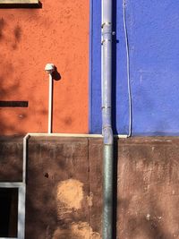 Close-up of pipes against blue wall