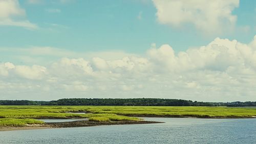 Scenic view of lake against cloudy sky