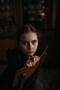 Portrait of young woman sitting on chair
