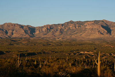 Scenic view of mountains against clear sky on sunny day