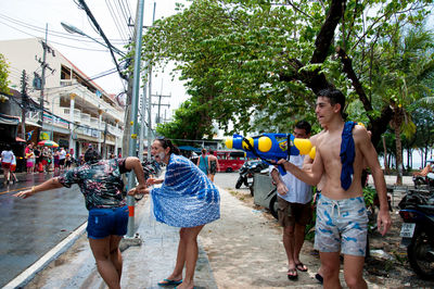 People holding umbrella in city